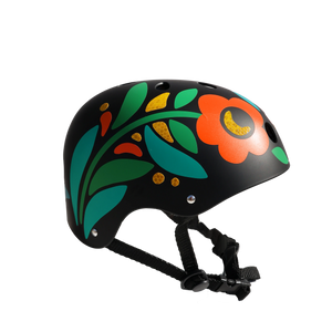 A black bicycle or skate helmet decorated with a retro 1970s-style floral pattern featuring teal, green, orange, and yellow leaves and flowers, shown against a plain background.